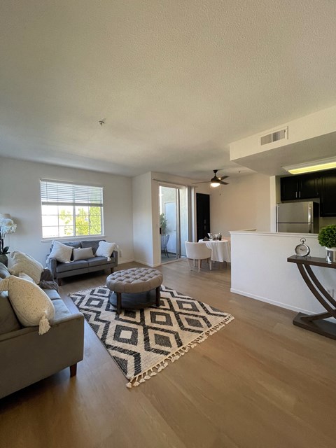 an open living room with a rug and a couch and a table
