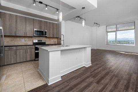 A kitchen with wooden cabinets and a white island.