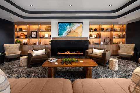 A modern living room with a fireplace and a large painting on the wall.