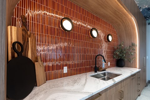 A kitchen with a wooden counter and a sink.