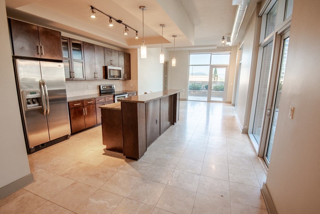 a kitchen with an island and stainless steel appliances