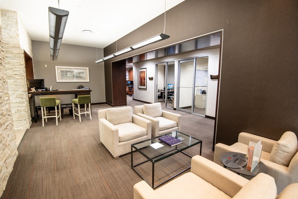 a living room filled with furniture and a large window