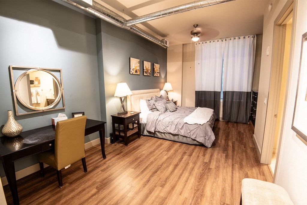 a bedroom with a bed and a desk