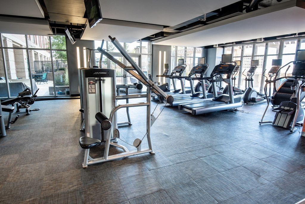 a gym with treadmills and other exercise equipment