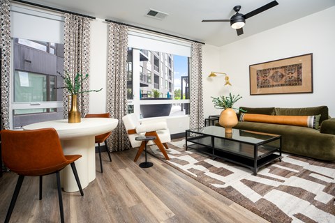 A living room with a brown rug and a white table.