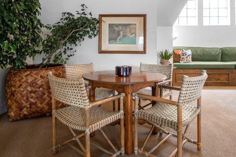 A dining room with a round table and chairs.