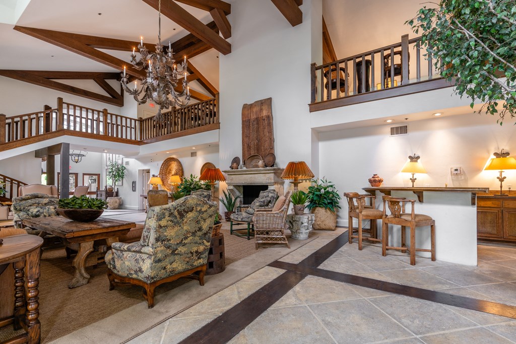 the living room of a house with a high ceiling and a fireplace