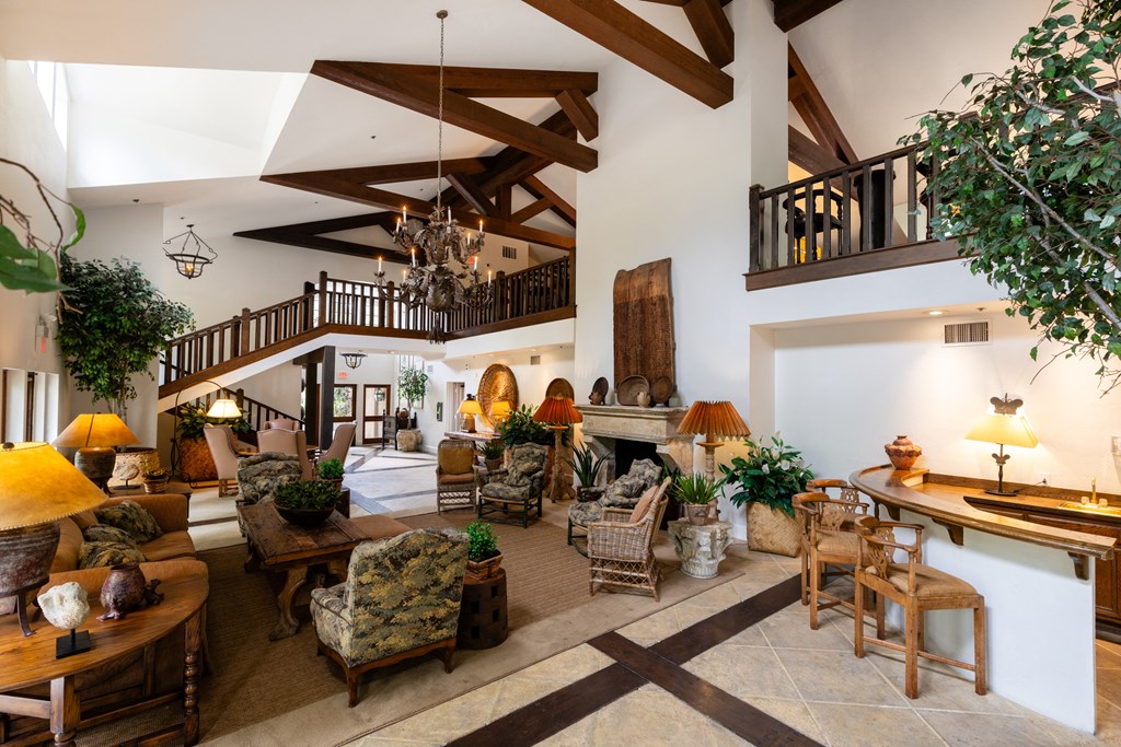 a large living room with a high ceiling and a fireplace