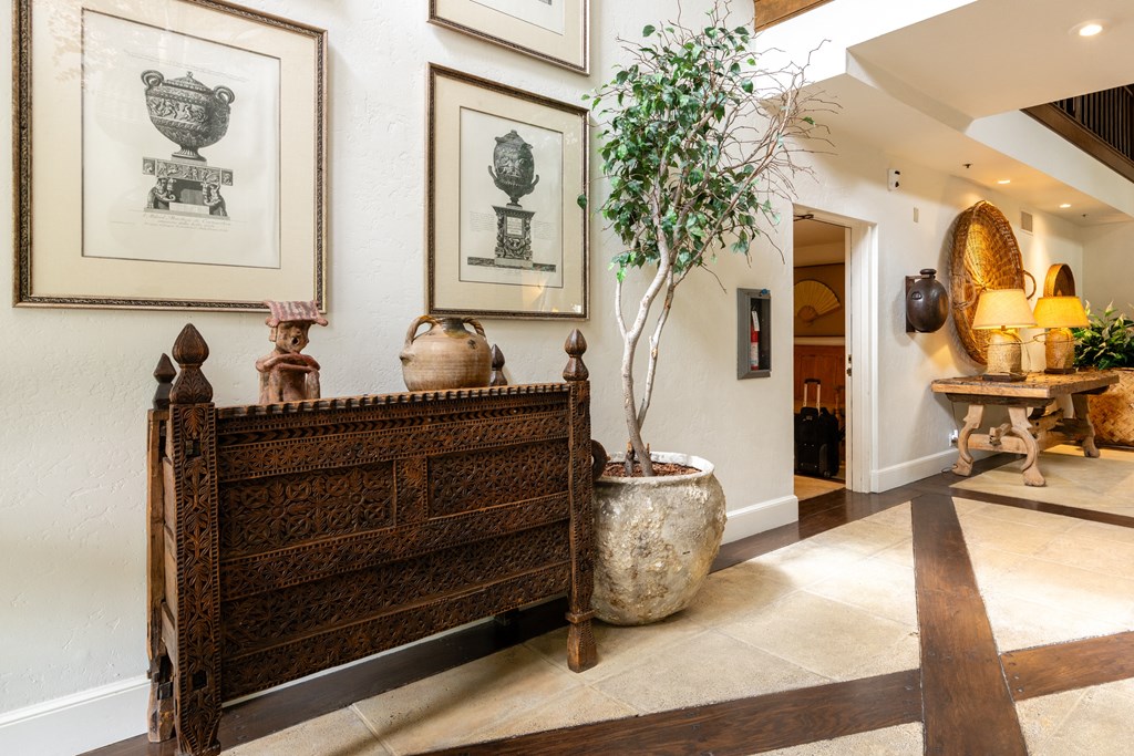 the lobby of a hotel with a couch and a potted plant