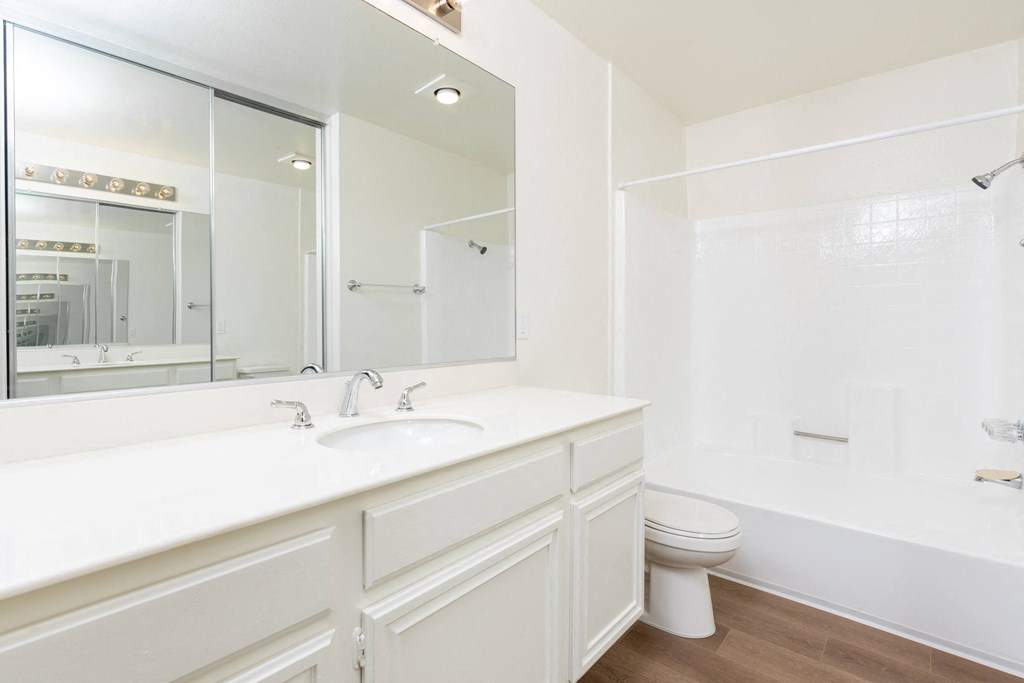 a bathroom with a sink toilet and a mirror