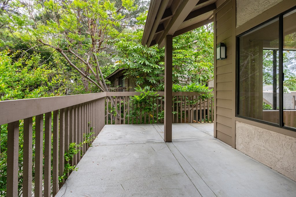 the private balcony has views of the trees and the yard