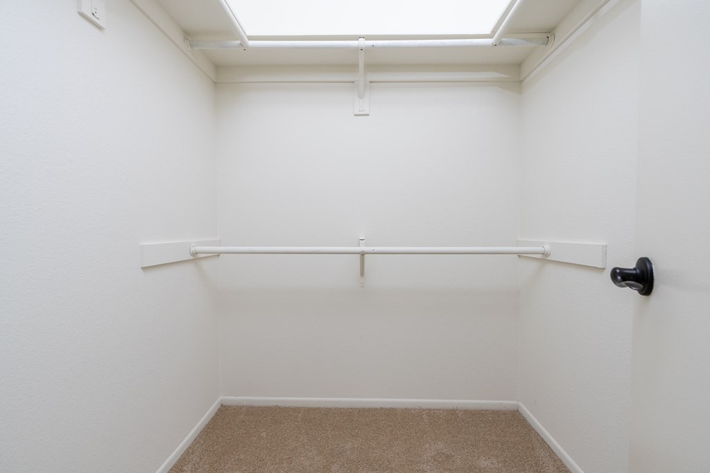 an empty room with a white wall and a window