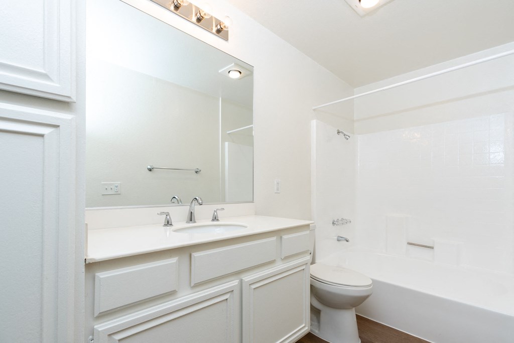 a bathroom with a sink toilet and a mirror