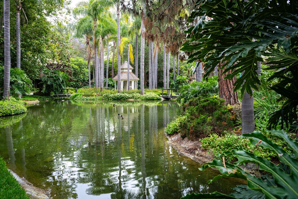 a small gazebo in the middle of a pond
