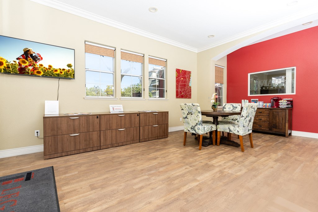 a dining room with red walls and a table and chairs