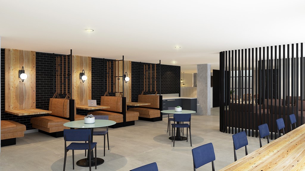 A modern cafe with blue chairs and wooden tables.