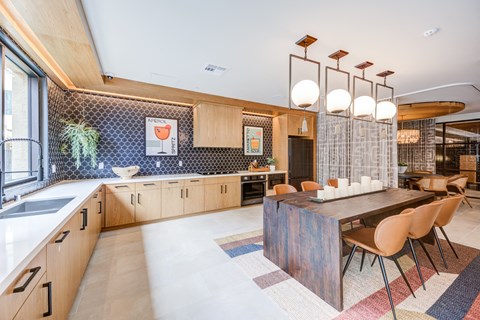 a kitchen with a long wooden table and chairs