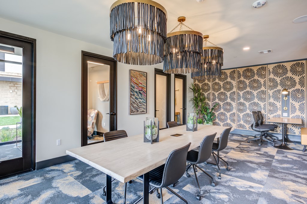 a conference room with a long table and chairs and a large chandelier