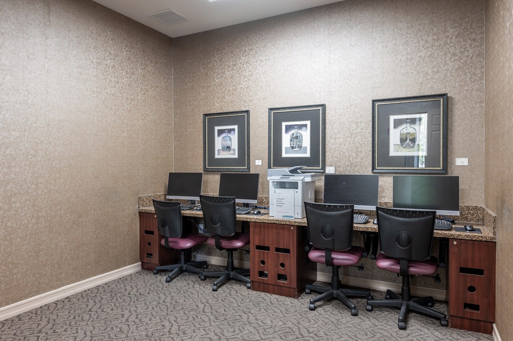 a conference room with four computer desks and chairs
