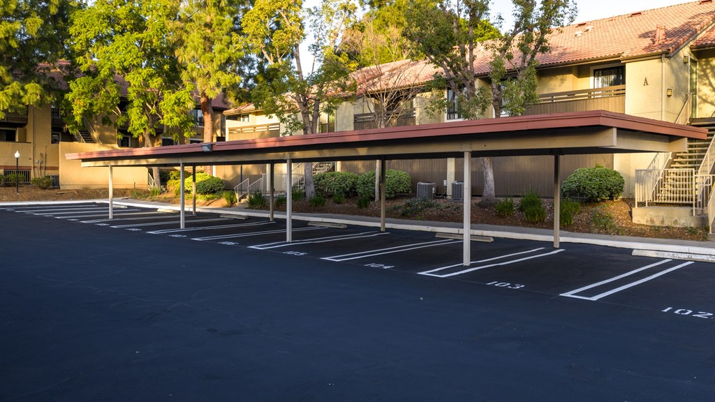 A parking lot with a building in the background.