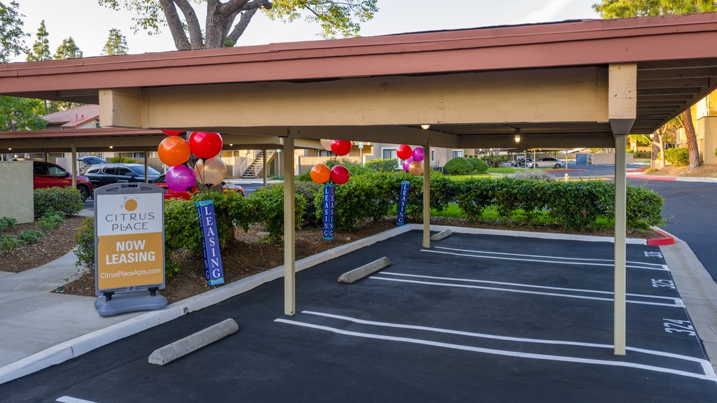 A Citrus Place leasing office with a canopy and parking lot.