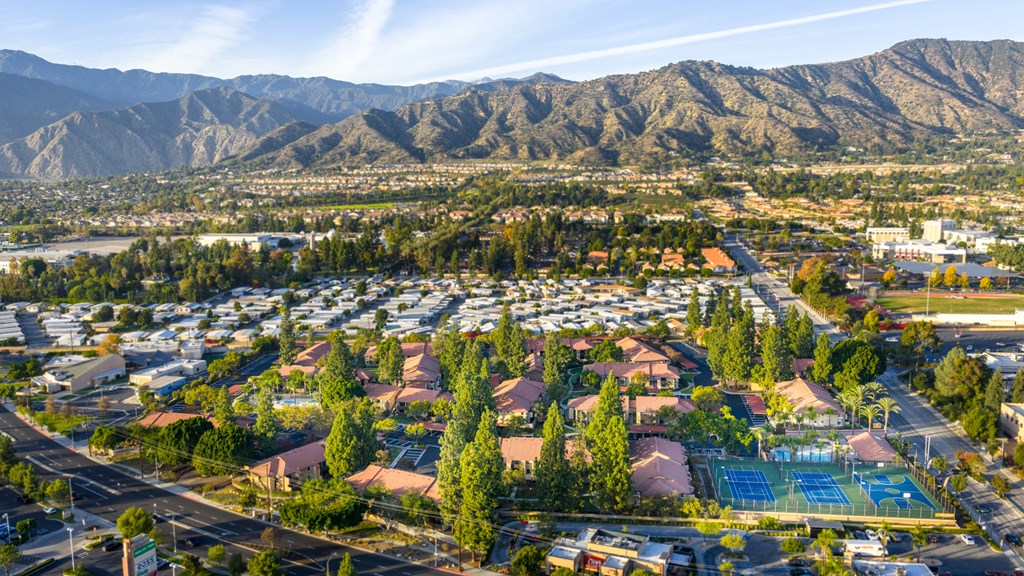 A suburban area with a swimming pool and a mountain range in the background.