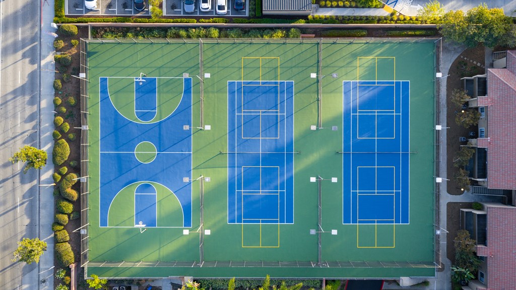 An aerial view of a basketball court surrounded by buildings.