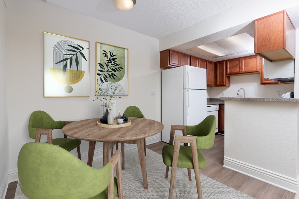 A dining room with a table and chairs.