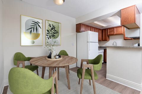 A dining room with a table and chairs.