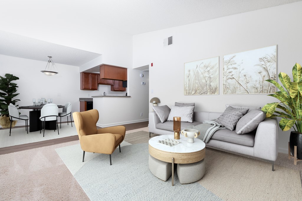 A living room with a grey couch, a yellow chair, and a coffee table.