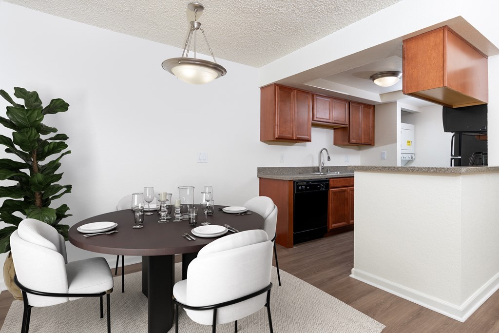 A modern dining room with a round table and chairs.