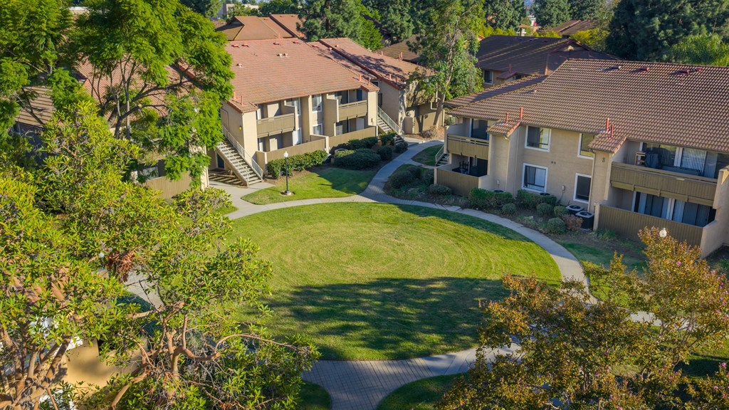 A residential area with houses and a green lawn.