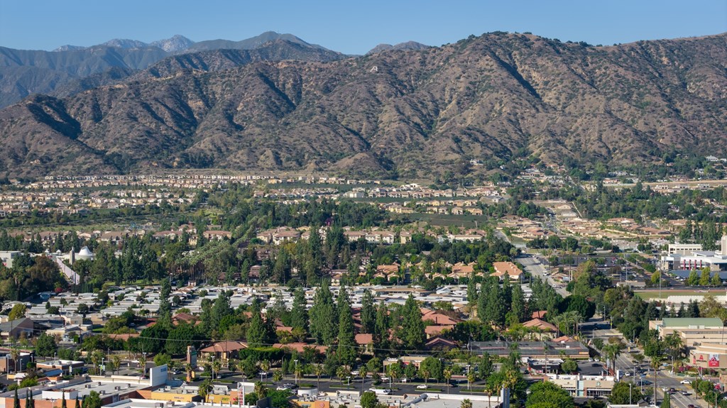 A mountain range rises behind a town.