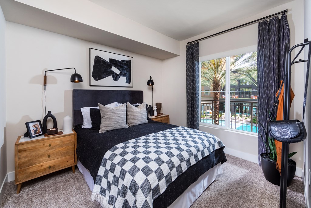 a bedroom with a bed and a view of a pool