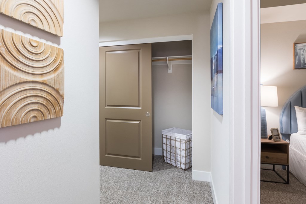 a bedroom with a closet and a door to a bathroom