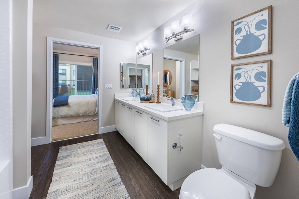 a bathroom with a toilet and a sink and a mirror