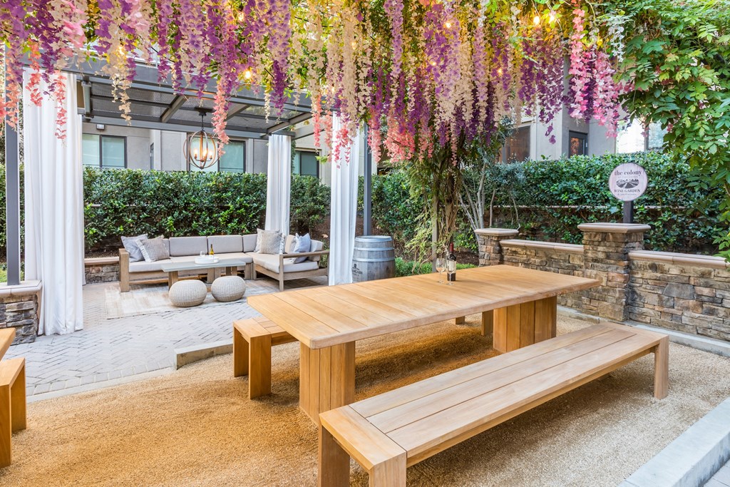 a communal picnic area with a wooden table and benches
