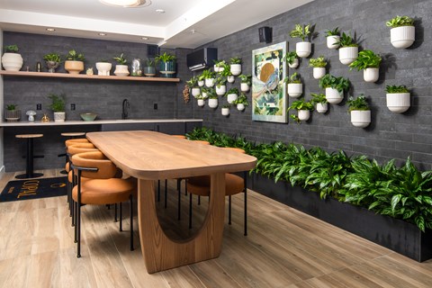 A modern dining area with a wooden table and chairs.