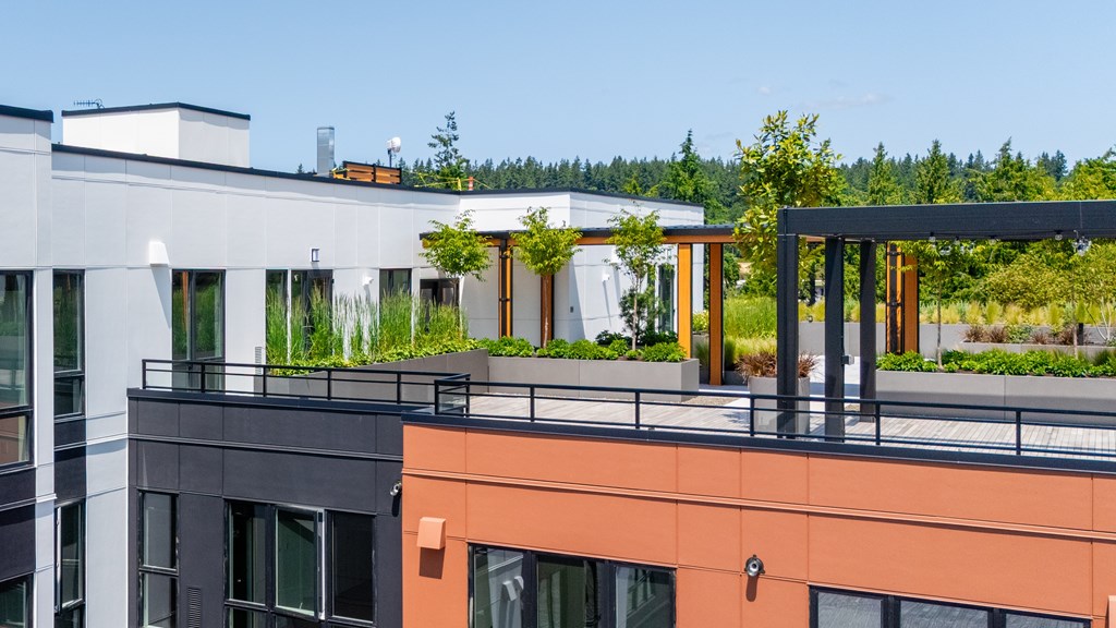 A modern building with a balcony and a tree.