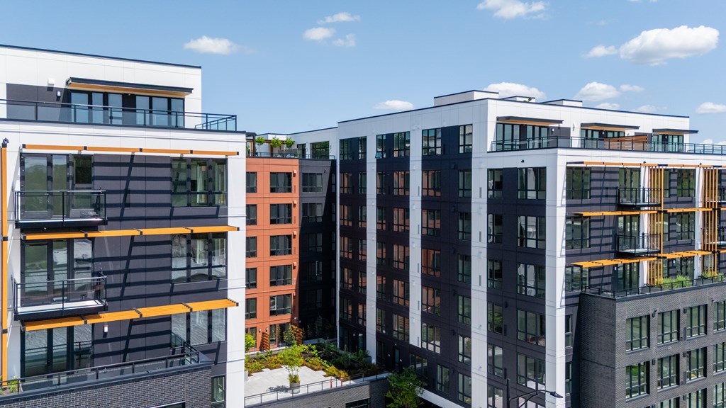 A modern building with a balcony and a glass wall.