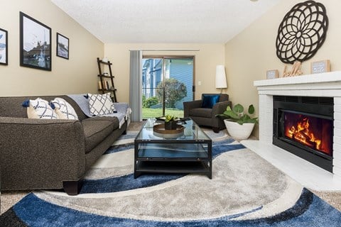 a living room with a fireplace at Copper Ridge Apartments, Renton  