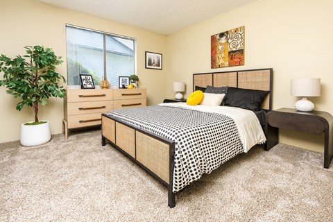 a bedroom with a bed and dresser at Copper Ridge Apartments, Renton Washington  