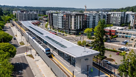 A train station with a train on the tracks.