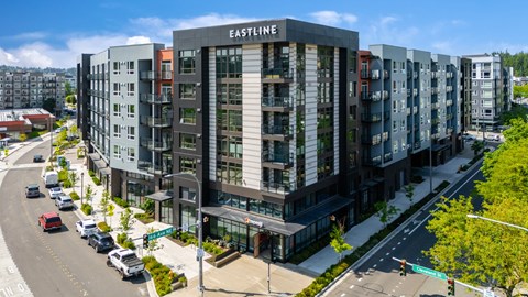 A street view of Eastline apartment complex with cars parked on the side of the road.