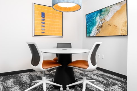 a conference room with a table and chairs