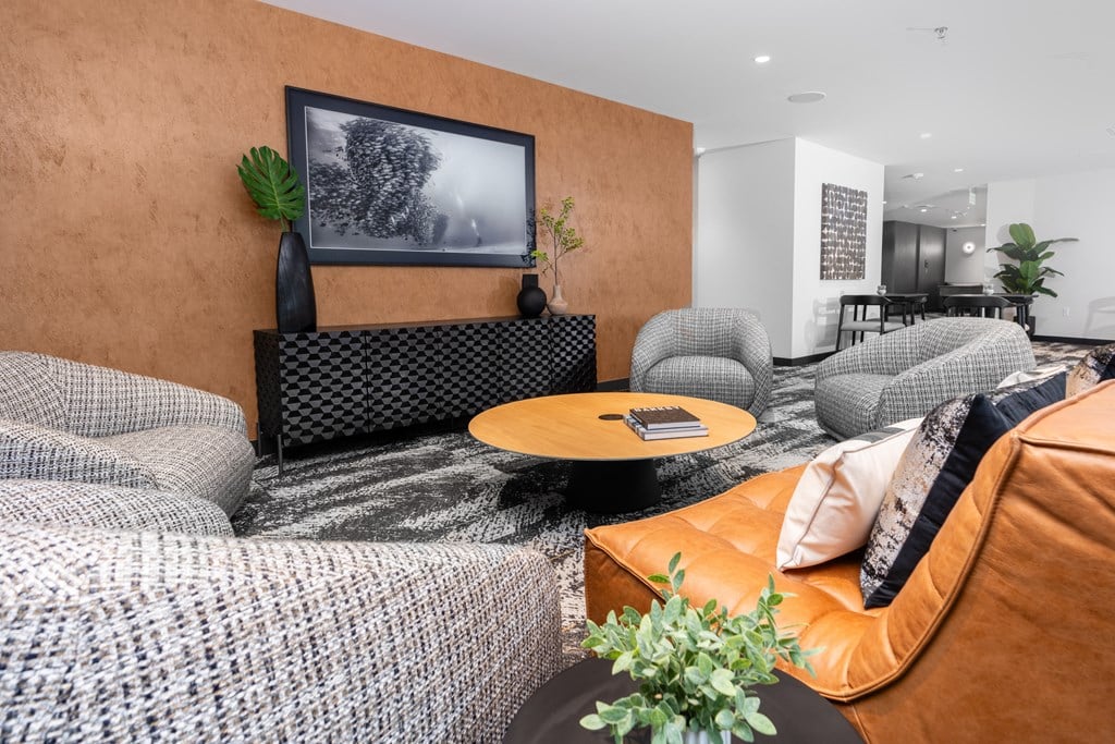 a living room with couches and chairs and a table