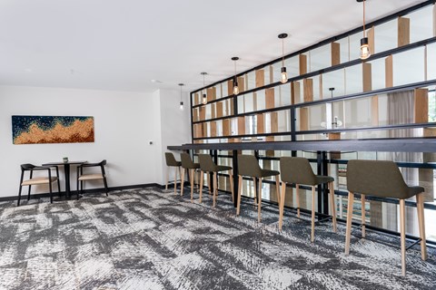 a dining room with a long table and chairs and a glass wall