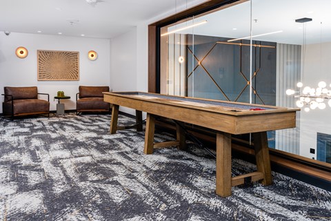 a pool table in a living room with a large mirror