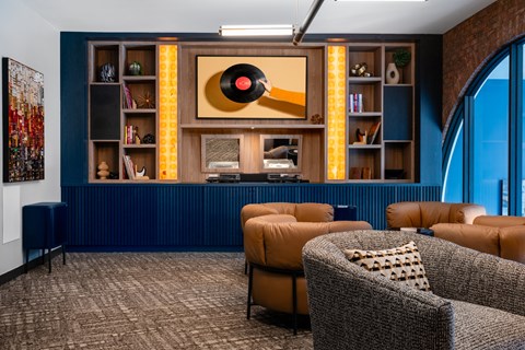 a living room with blue walls and brown couches and a yellow and orange wall