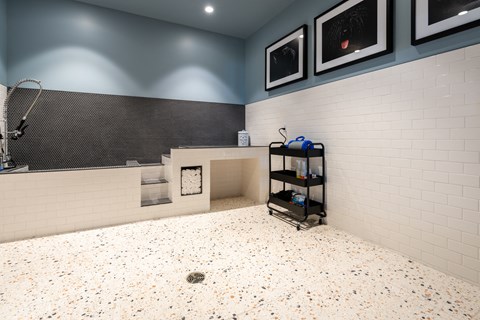 a bathroom with a shower and a sink and a tile floor